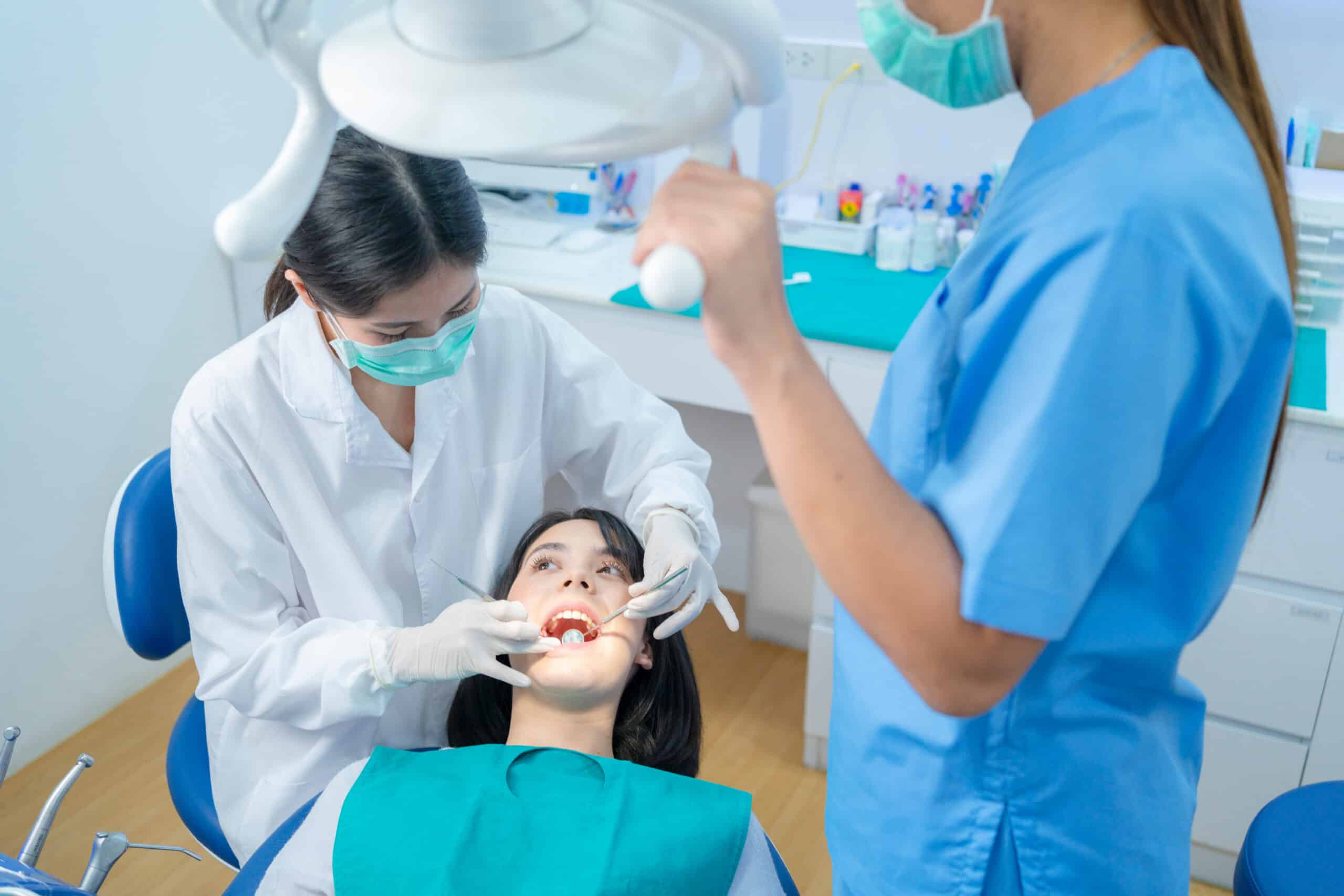Smiling attractive Asian young woman in casual dress representing benefits of dental sealants in Vancouver